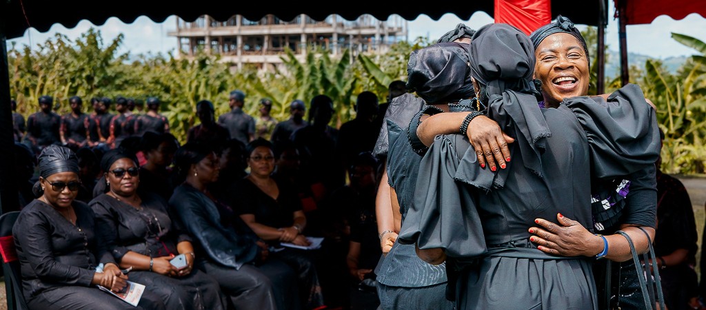 Loved ones embracing at an outdoor memorial gathering